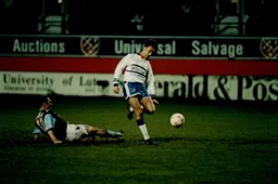 Scott Oakes skips past Alvin Martin