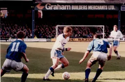 Julian James takes on two Peterborough defenders