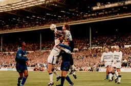 Dmitri Kharine catches the ball off Kerry Dixon`s head