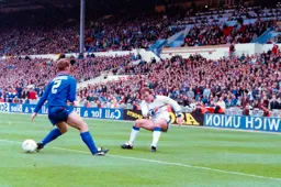 Kerry Dixon slips the ball through the Chelsea defenders legs