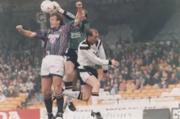 Vale goalkeeper Paul Musselwhite punches the ball off the head of Kerry Dixon