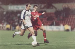 Kerry Dixon has the better of Swindon's Kevin Horlock