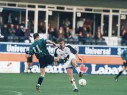 Julian James tangles with United's Andy Scott