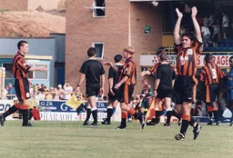 Tony Thorpe salutes the fans after the 1-0 win for the ten man Hatters