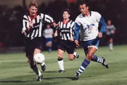 Des Linton in a chase for the ball with Grimsby's Mark Lever