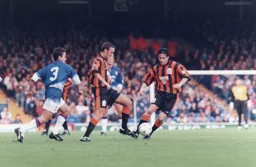 Ceri Hughes takes the ball of the toe of Scott Oakes to set up another attack