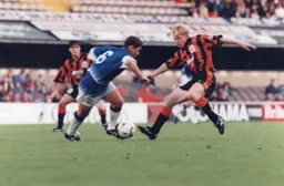 Gary Waddock about to tackle Geraint Williams