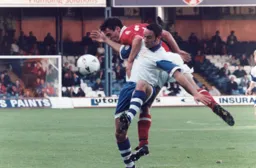 Under pressure, Scott Oakes protects the ball