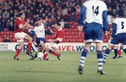 A crunching tackle stops Julian James