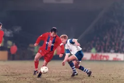Gary Waddock tries to win the ball from Ray Houghton