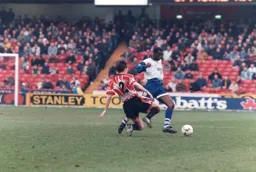 Mitchell Thomas about to be tackled by Gary Ablett