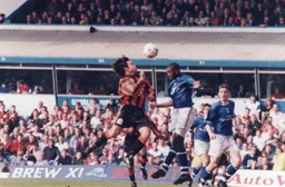 Substitute Graeme Tomlinson attacks the ball