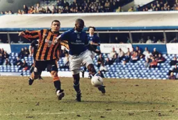 Kim Grant sees the ball hacked clear