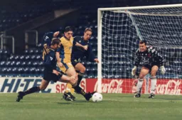 Tony Thorpe battles away as the Town record another shock, holding Premiership Wimbledon to a draw away from home