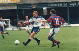 Gary Waddock is closed down by Paul Reid