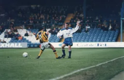 Richard Harvey plays the ball past Leon Hapgood