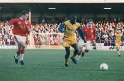 Chris Allen is closed down by two Wrexham defenders