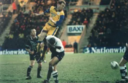 David Oldfield leaps over a Preston player