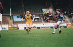 Garry Waddock plays thje ball forward
