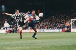 Dwight Marshall gets involved in some high kicking with John McDermott