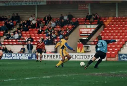 Dwight Marshall goes round Jimmy Walker to set up Town`s third goal