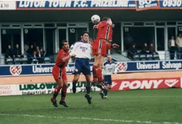 Rory Allen is sandwiched between two York defenders