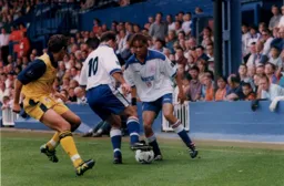 Liam George and Phil Gray blocking the Colchester player from the ball