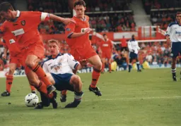 Jimmy Cox challenges for the ball