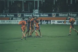 Steve Davis is mobbed by his teammates in celebration after scoring the second goal