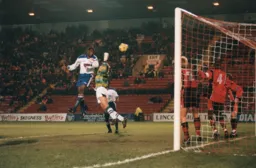 Mitchell Thomas powers a header at goal