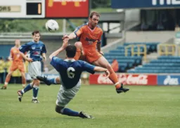 Phil Gray jumps over an incoming tackle