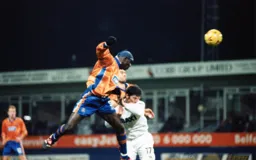 Efe Sodje and Julian Watts win this aerial battle but the Town slip to their first home defeat