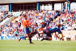 Phil Gray well beaten by the diving Gills defender
