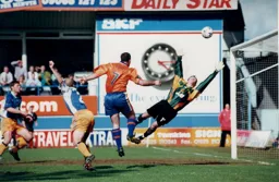 Phil Gray rises to score the Town goal in a one all draw
