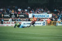 Andre Scarlett is blocked by Martin Taylor