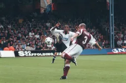 Andre Scarlett attempts to block John Frain`s clearance