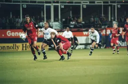 Mark Stein gets between two defenders to fire off a shot