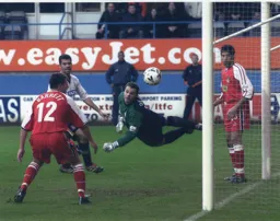 A diving Kevin Dearden cannot stop Julian Watts header scoring Town`s second goal
