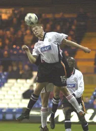 Matt Taylor strains every neck muscle to head the ball