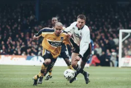 Matt Taylor in a tussle for the ball with Marcus Bignot