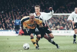 Marcus Bignot shields the ball away from Matt Taylor