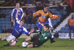 Future Town keeper Mark Tyler gets down to block Mark Stein
