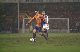 Matt Spring brings the ball forward as Tony Shields gives chase
