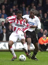 Emmerson Boyce gets to grips with Kyle Lightbourne