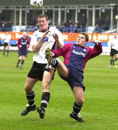 Steve Howard grimaces as Scott McNiven goes in with a high boot