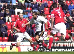 Liam George skips between two defenders
