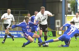 Steve Howard is blocked by the Carlisle defenders