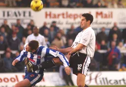 Chris Coyne wins a heading duel