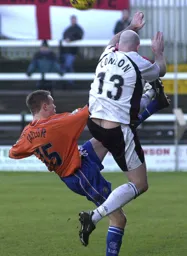 Matthew Taylor hacks the ball away