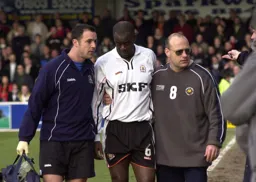Marvin Johnson is helped from the pitch